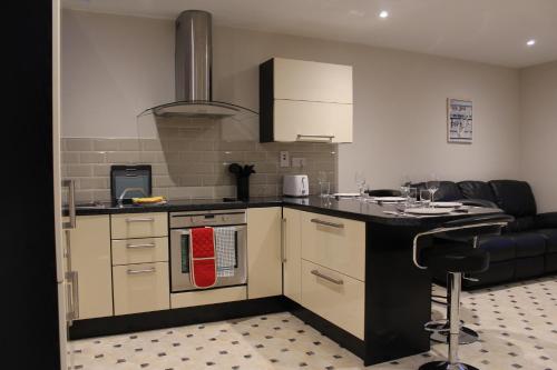 a kitchen with a stove top oven next to a couch at Dunneill River Rest in Charlesfort