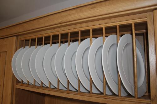 a wooden cabinet with white plates in it at Dunneill River Rest in Charlesfort