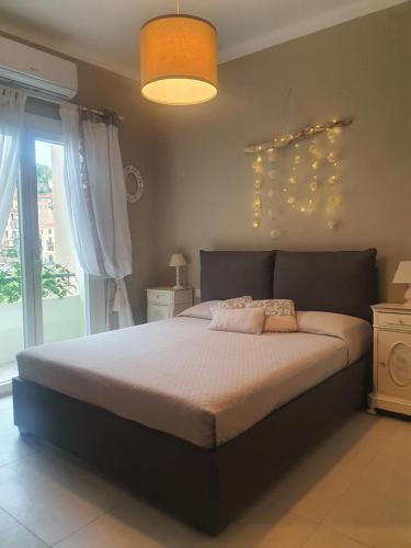 a bedroom with a large bed and a large window at La Roja Grand apartement luxury 3 bedrooms in Ventimiglia