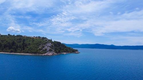 an island in the middle of a large body of water at Apartman Natali in Kremena
