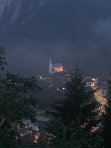 a view of a city at night with a christmas tree at La taverna dei folletti in Valle di Cadore