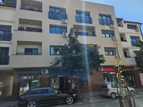 a black car parked in front of a building at Apartman Sky in Sremska Mitrovica