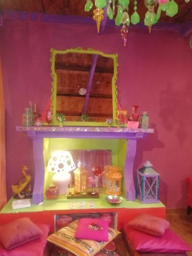 a room with a fireplace with a pink wall at Suite d'Artista Calcata in Calcata