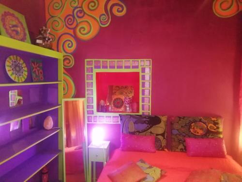 a bedroom with a pink room with a bed and a shelf at Suite d'Artista Calcata in Calcata