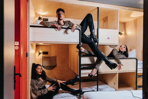 a group of people sitting on top of bunk beds at La Folie Douce Hotels Chamonix in Chamonix-Mont-Blanc