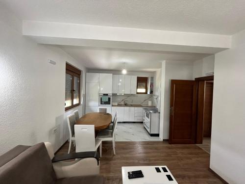 a living room with a table and a kitchen at Vila Kiko in Plav