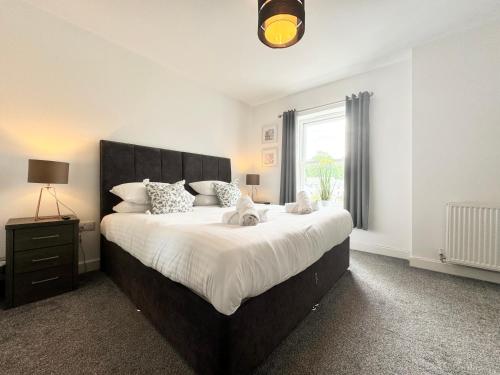 a bedroom with a large bed and a window at The Town House inn, Ulverston - Lake District in Ulverston