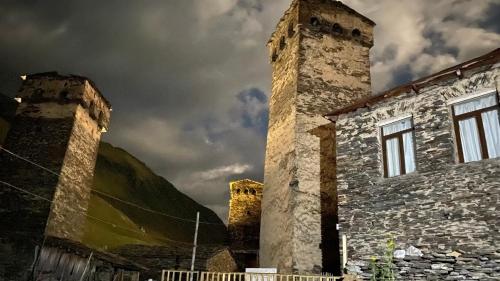 an old stone building with two towers on top of it at Nizharadze's Tower in Ushguli