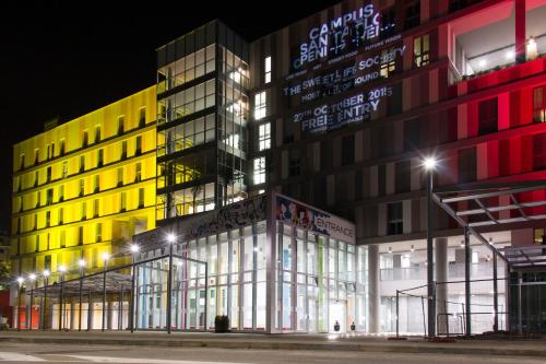 a large building with lights on it at night at Hotel Campus Sanpaolo in Turin