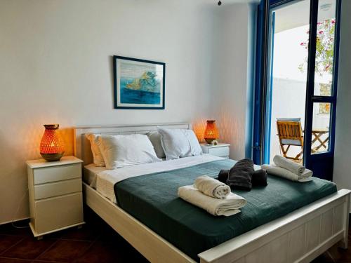 a bedroom with a bed with towels on it at Paros Home in Kampos Paros