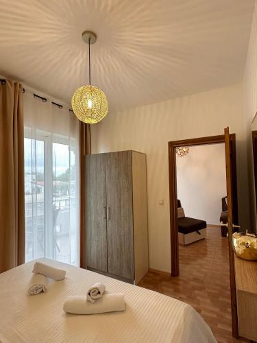 a bedroom with a bed and a large mirror at Apartmens Xhenis Lux in Ulcinj