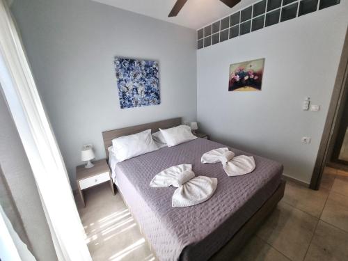 a bedroom with a bed with two pillows on it at Connie's Beach House in Kos Town