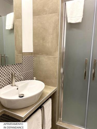 a bathroom with a sink and a shower at Tenute Plaia Agriturismo in Scopello