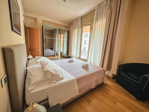 a bedroom with a bed and a large window at Casa Paolina in Lucca