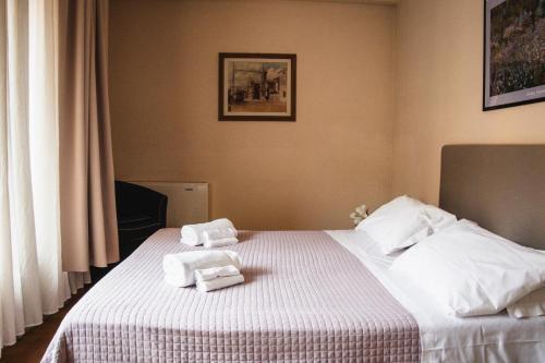 a hotel room with a bed with towels on it at Casa Paolina in Lucca