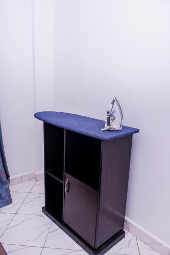 a black counter with a sink on top of it at The pine 1 bedroom house California plaza in Nanyuki