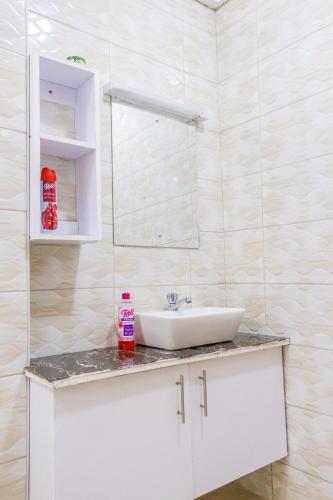 a bathroom with a sink and a mirror at The pine 1 bedroom house California plaza in Nanyuki