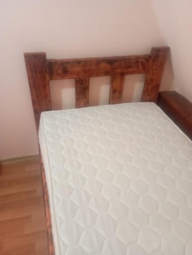 a bed in the corner of a room at Rooms Apartment Durmitor in Žabljak