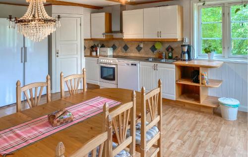 a kitchen with a wooden table and a dining room at Cozy Home In Tranås With Kitchen in Tranås