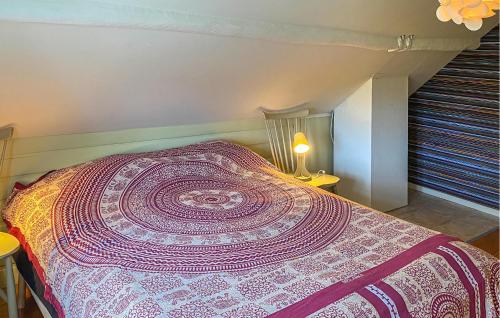 a bedroom with a bed with a purple and white bedspread at Cozy Home In Tranås With Kitchen in Tranås