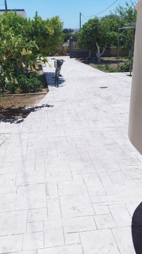 a bike is parked on a brick driveway at ΒΡΑΧΑΤΙ-Vrachati Family apartment in Vrahati