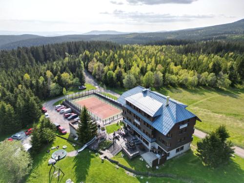 an aerial view of a large house in the mountains at Hotel Oddech in Pec pod Sněžkou