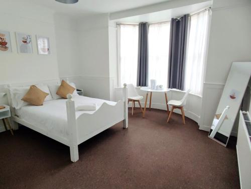a bedroom with a bed and a table and chairs at Horizon in Brighton & Hove