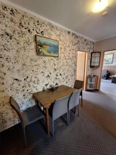 a dining room with a wooden table and chairs at VILLA VOLOSKO with private parking and breakfast,seaview in Volosko