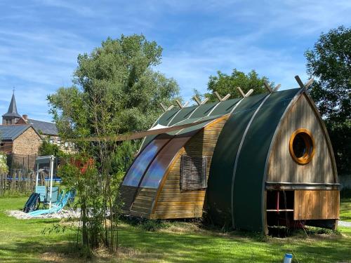a large wooden hobbit house in a yard at Bungalow accueillant à Saint-Pardoux avec piscine partagée in Saint-Pardoux