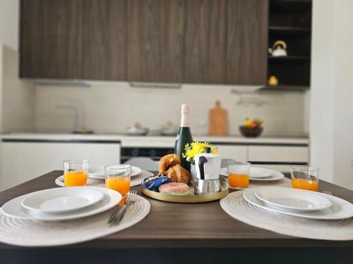 a table with plates of food and a bottle of wine at Grey House 5 100mt dal mare in Tortoreto Lido