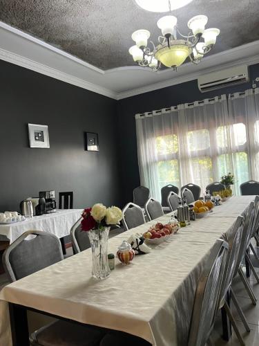 a long table in a room with chairs at TRMOTEL in Matola