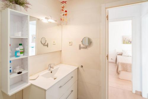 a bathroom with a sink and a mirror at Inspira by Unik Vacation in Torredembarra