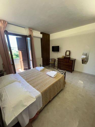 a bedroom with a large bed and a television at Casa Isa in Narni Scalo