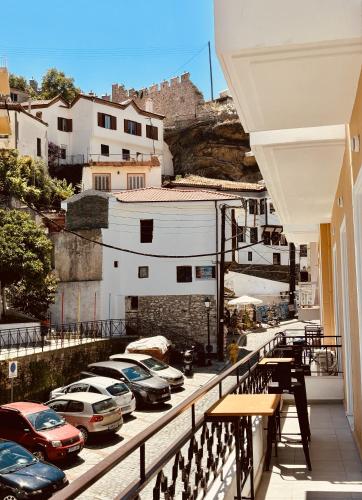 a balcony with cars parked in a parking lot at Iridium Old Town Luxury Suites in Kavala