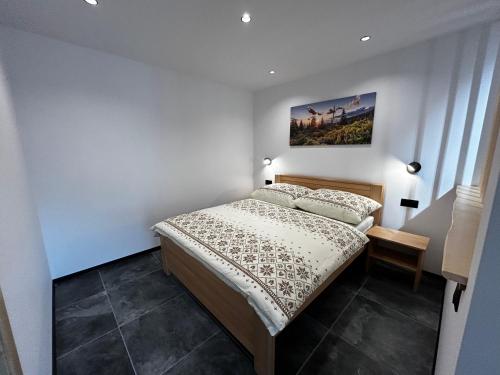 a bedroom with a bed and a painting on the wall at Horska Rezort in Ružomberok