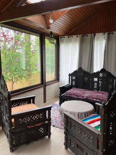 two beds in a room with windows at Ker Lann in Paimpont