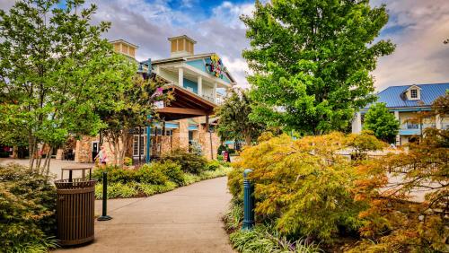a house on a street with trees and a sidewalk at Margaritaville Island Hotel in Pigeon Forge