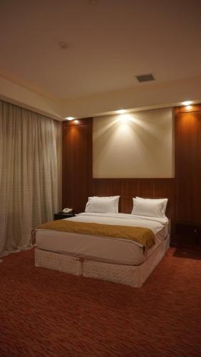 a bedroom with a large bed in a hotel room at Golden Beach by ShamBaku in Baku