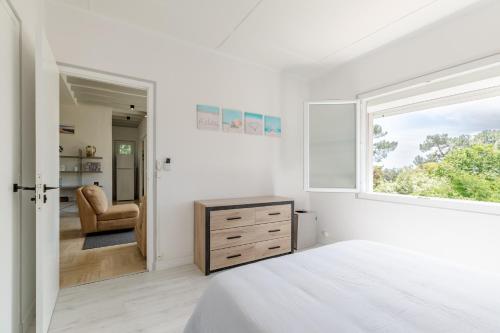 a bedroom with a bed and a window and a chair at Bista Eder in Pyla-sur-Mer