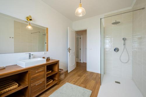 a bathroom with a sink and a shower at Hydrangea House in Água de Pau