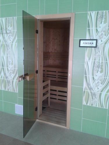 a walk in shower in a bathroom with a glass door at Hotel Vila Anna in Trenčianske Teplice