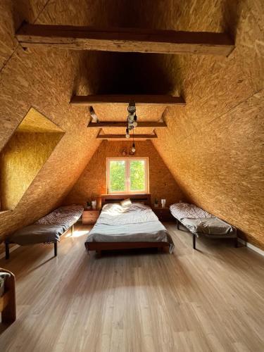 a large room with two beds and a window at LUCE Chata in Nieledwia