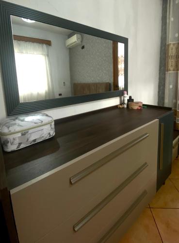a large mirror above a dresser in a room at At-Salaj1 in Vlorë