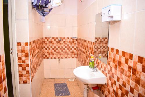 a small bathroom with a sink and a shower at House of Grace Nakuru Naka Area Airbnb in Nakuru
