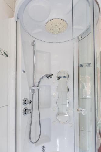 a bathroom with a shower with a glass door at Residenz Ambassador in Leukerbad