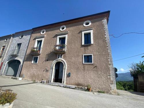 a large brick building with windows and a balcony at La Zizzania e il Mandarino in Roccagloriosa