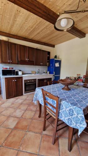 a kitchen with a table with a blue table cloth at Casa della Zagara in Acireale
