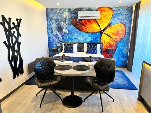 a bedroom with a large butterfly painting on the wall at Luxury Apartments Keszthely in Keszthely