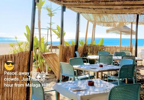 a restaurant with tables and chairs on the beach at Malaga Hills Double Comfort Boutique & Wellness Eco-Hotel -Adults Only- in Cómpeta