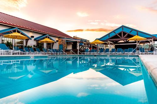 a pool at a resort with chairs and umbrellas at Margaritaville Island Hotel in Pigeon Forge